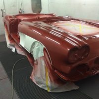 corvette painted red still in the paint booth